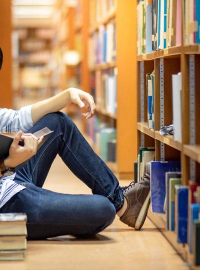 Student reading in a library